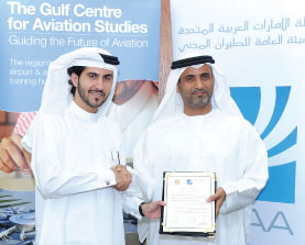 H.E. Saif Mohamed Al Suwaidi, Director General of General Civil Aviation Authority, delivers the certificate to Mohammed Al Bulooki, General Manager Gulf Centre for Aviation Studies (GCAS) in ADAC at GCAA headquarters.