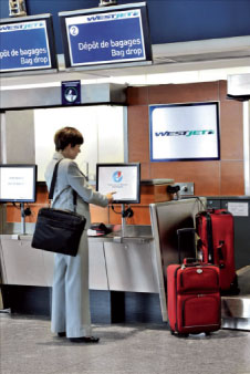 At Montréal-Trudeau Airport, Westjet passengers can use kiosks to check-in and print their baggage tags.