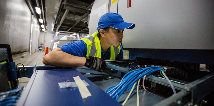 One of Morpho Detection’s Field Service Engineers working on a 9800 C TX™ EDS. Photo: Christopher Jue / Safran